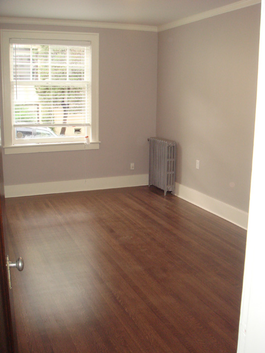 Bright living room with hardwood floors at Beaufort Mansions