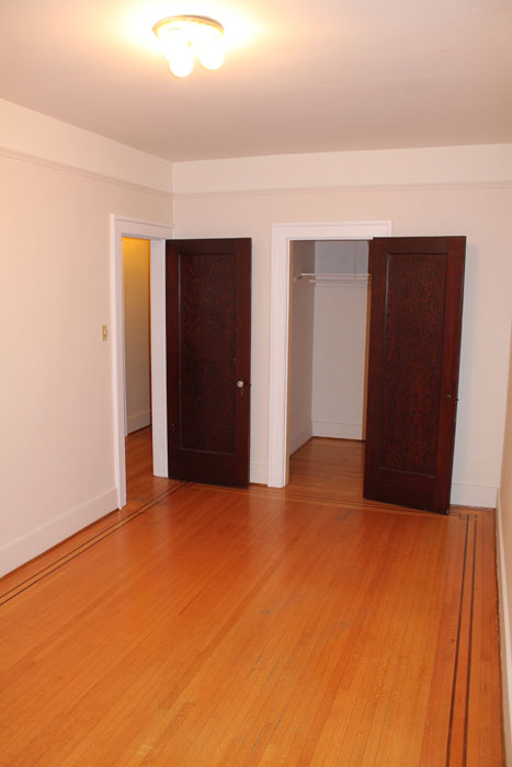 Bright bedroom with hardwood floors at Seafield Apartments